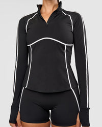Woman wearing Power Quarter Zip Jacket - Black | Model:Rhiley | Size:S