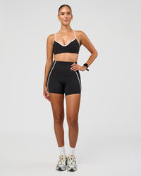 Woman wearing Power Ultra High-Rise 4" Short Pockets - Black | Model:Rhiley | Size:S