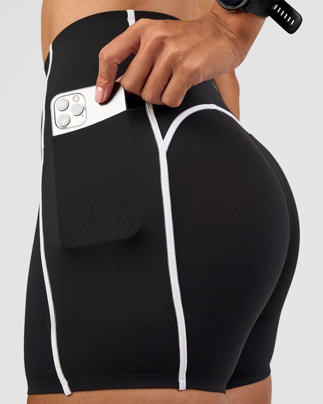 Woman wearing Power Ultra High-Rise 4" Short Pockets - Black | Model:Rhiley | Size:S