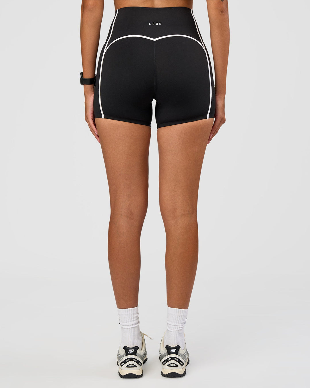 Woman wearing Power Ultra High-Rise 4" Short Pockets - Black | Model:Rhiley | Size:S