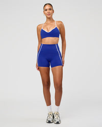 Woman wearing Power Ultra High-Rise 4" Short Pockets - Electric Indigo | Model:Rhiley | Size:S