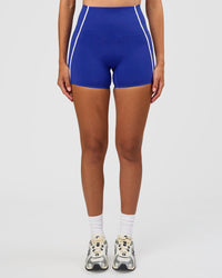 Woman wearing Power Ultra High-Rise 4" Short Pockets - Electric Indigo | Model:Rhiley | Size:S