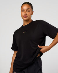 Woman wearing Pride Go-To FLXCotton Oversized Tee - Black | Model:Rosie | Size:S