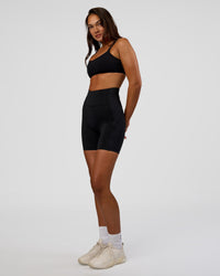 Woman wearing Progression Ultra High-Rise 6" Short - Black | Model:Kirstyn | Size:S