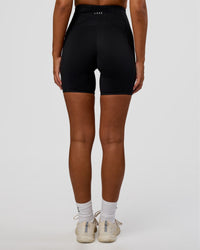 Woman wearing Progression Ultra High-Rise 6" Short - Black | Model:Kirstyn | Size:S