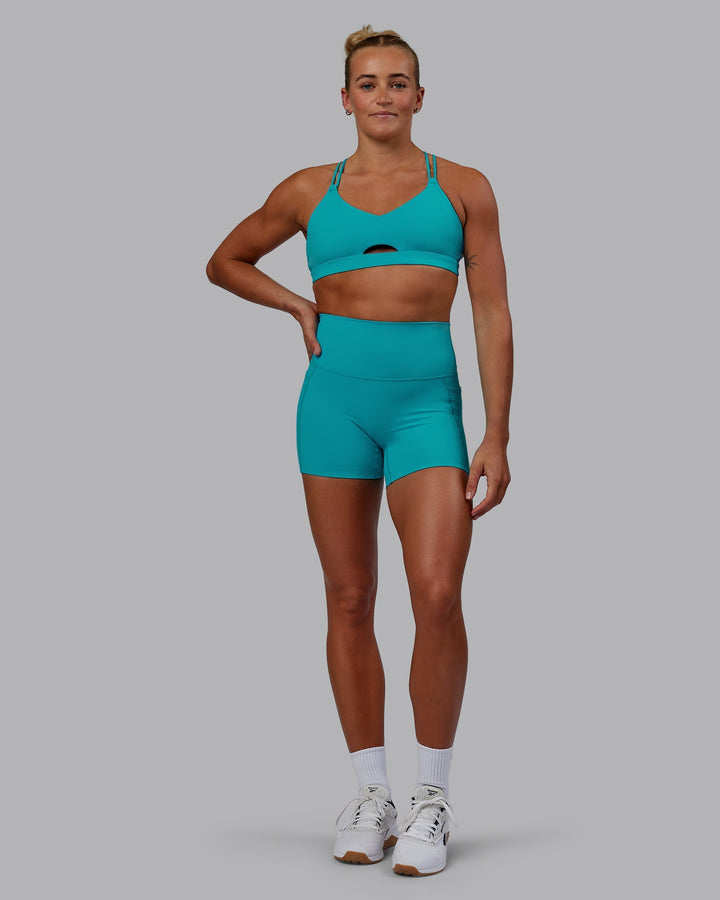 Woman wearing Pursue Sports Bra - Blue Bird
