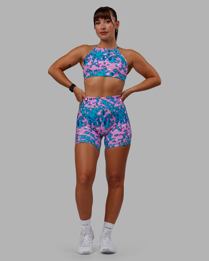 Woman wearing RXD Mid-Length Shorts - Neon Camo
