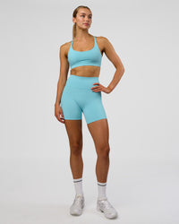 Woman wearing Rapid Sports Bra - Baltic Sea | Model:Evie | Size:S