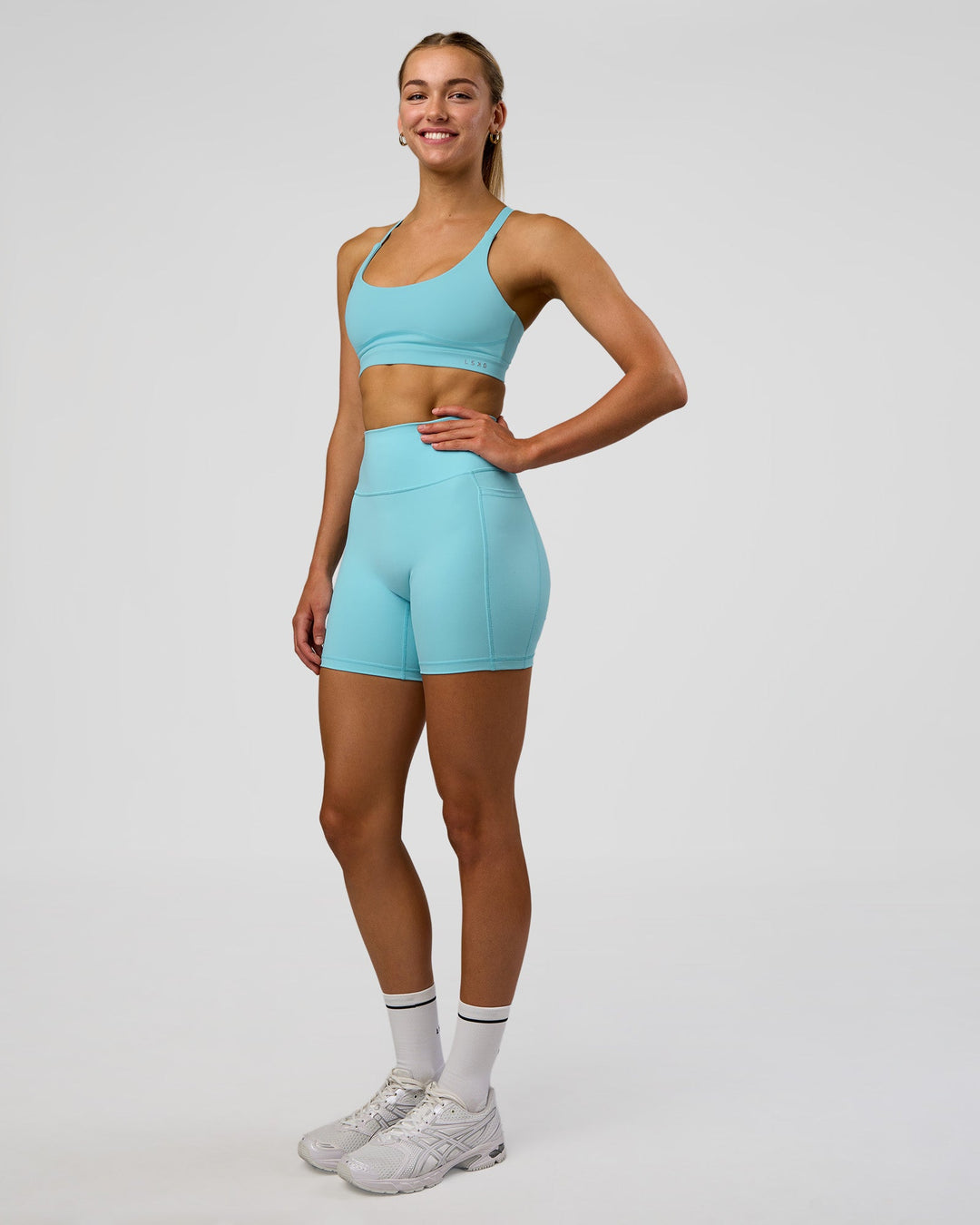 Woman wearing Rapid Sports Bra - Baltic Sea | Model:Evie | Size:S