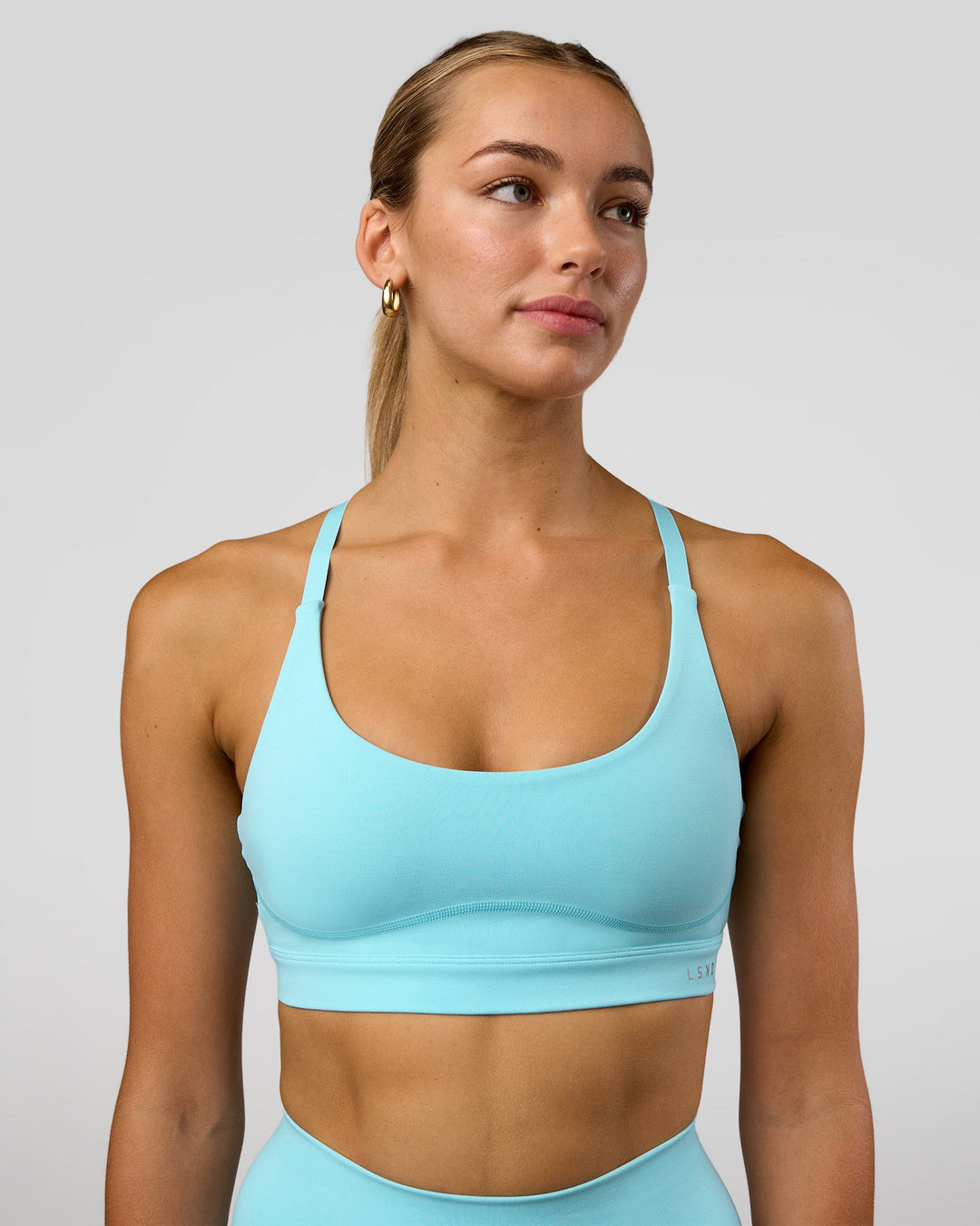 Woman wearing Rapid Sports Bra - Baltic Sea | Model:Evie | Size:S