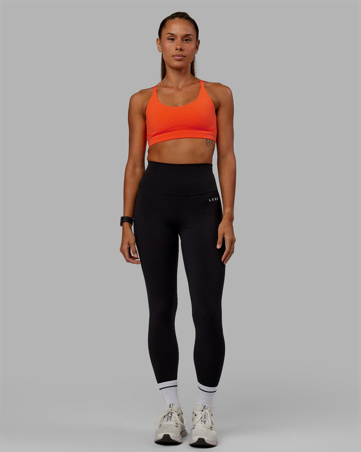 Woman wearing Rapid Sports Bra - Ultra Orange
