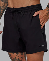 Man wearing Rep 5" Lined Performance Shorts in Black | Size:S