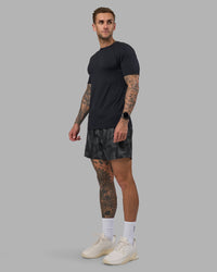 Man wearing Rep 5" Performance Short - Lunar Glow Print | Model:Tommy | Size:S