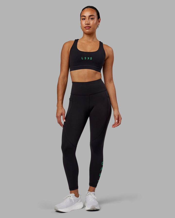 Woman wearing Rep 7/8 Length Leggings - Black-Impact Green
