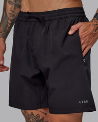 Man wearing Rep 7'' Performance Short in Black-White | Size:S
