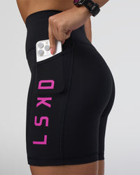 Woman wearing Rep Ultra High-Rise 6" Short Pockets - Black-Ultra Fuchsia | Model:Abbey | Size:S