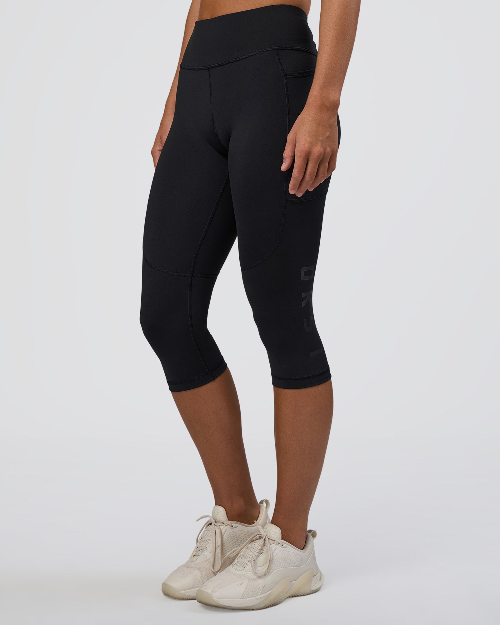 Woman wearing Rep Ultra High-Rise 3/4 Legging Pockets - Black-Black | Model:Amity | Size:S