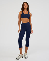 Woman wearing Rep Ultra High-Rise 3/4 Legging Pockets - Future Navy-White | Model:Dakota | Size:S