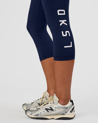 Woman wearing Rep Ultra High-Rise 3/4 Legging Pockets - Future Navy-White | Model:Dakota | Size:S