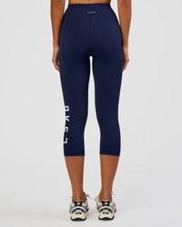 Woman wearing Rep Ultra High-Rise 3/4 Legging Pockets - Future Navy-White | Model:Dakota | Size:S
