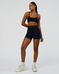 Woman wearing Rep Ultra High-Rise 4" Short Pockets - Black-Palace Blue | Model:Rosie | Size:S