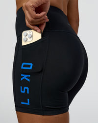Woman wearing Rep Ultra High-Rise 4" Short Pockets - Black-Palace Blue | Model:Rosie | Size:S