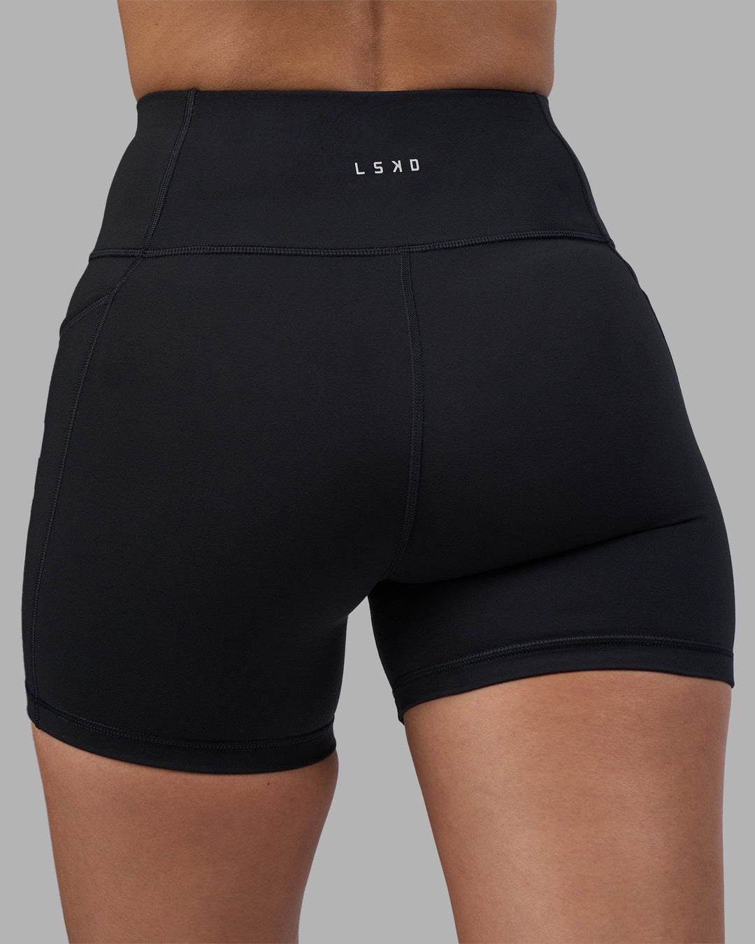 Woman wearing Rep Ultra High-Rise 4&quot; Short Pockets - Black-Power Cobalt | Model:Rhiley | Size:S