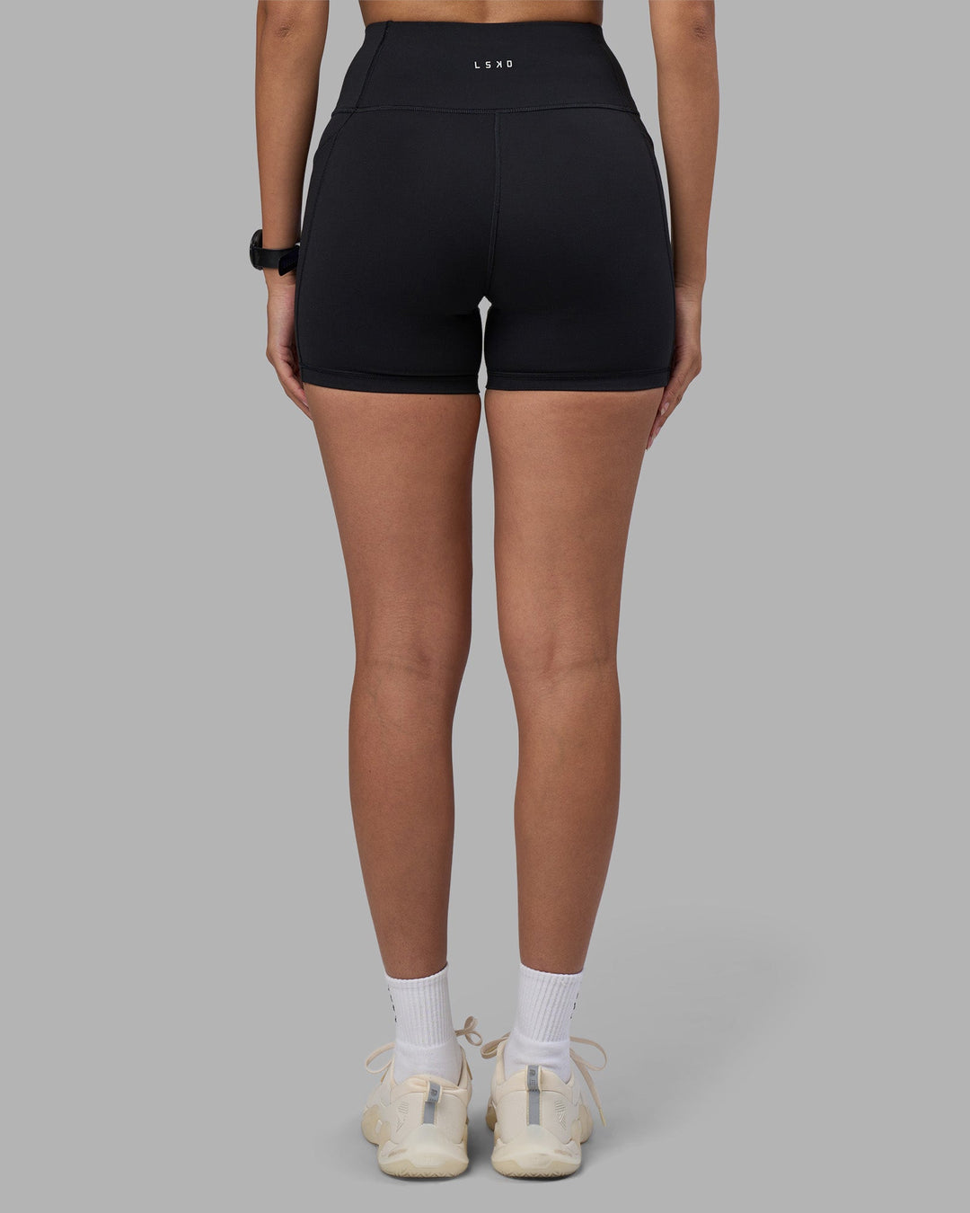 Woman wearing Rep Ultra High-Rise 4&quot; Short Pockets - Black-Power Cobalt | Model:Rhiley | Size:S