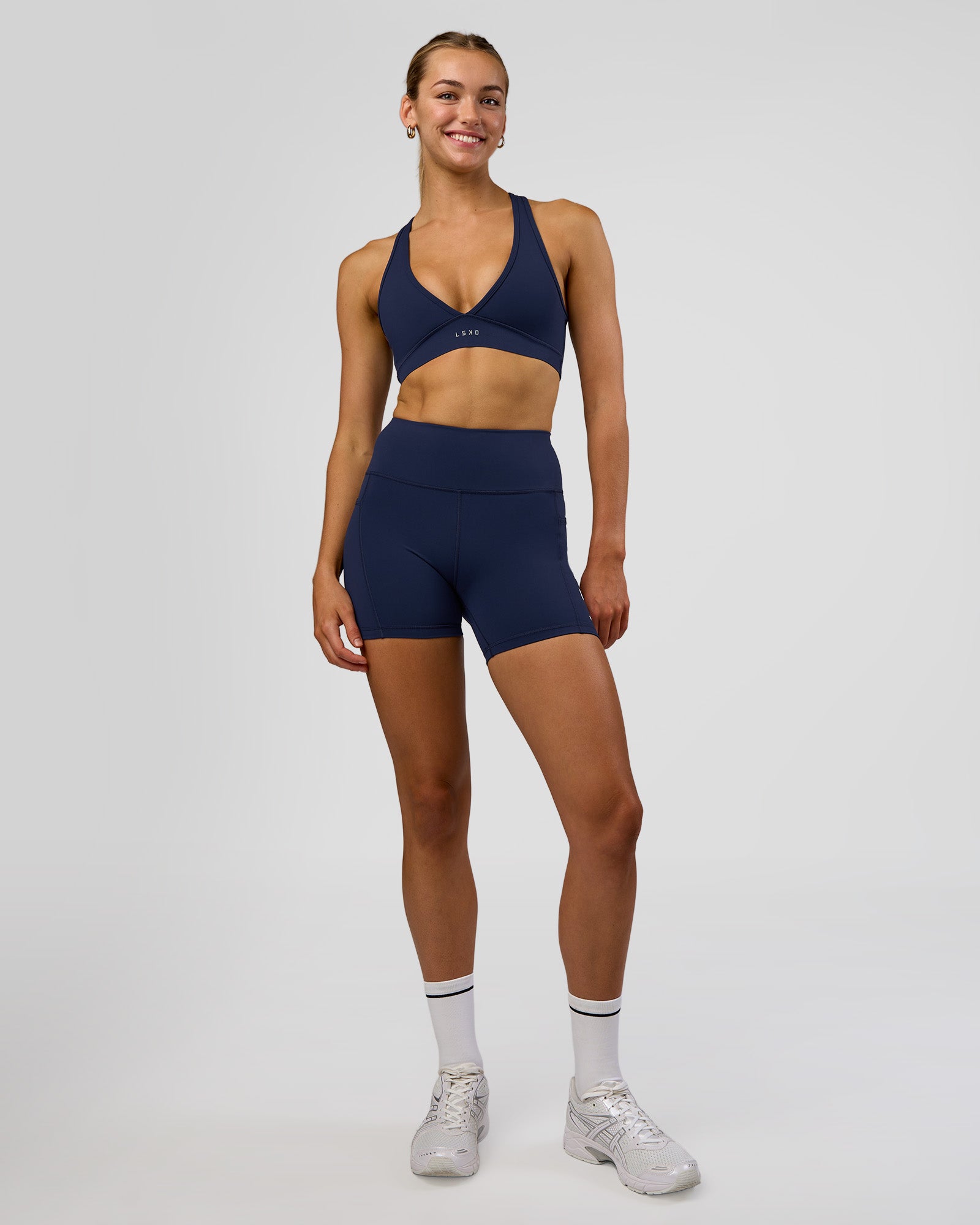 Woman wearing Rep Ultra High-Rise 4" Short Pockets - Future Navy-White | Model:Evie | Size:S