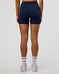 Woman wearing Rep Ultra High-Rise 4" Short Pockets - Future Navy-White | Model:Evie | Size:S