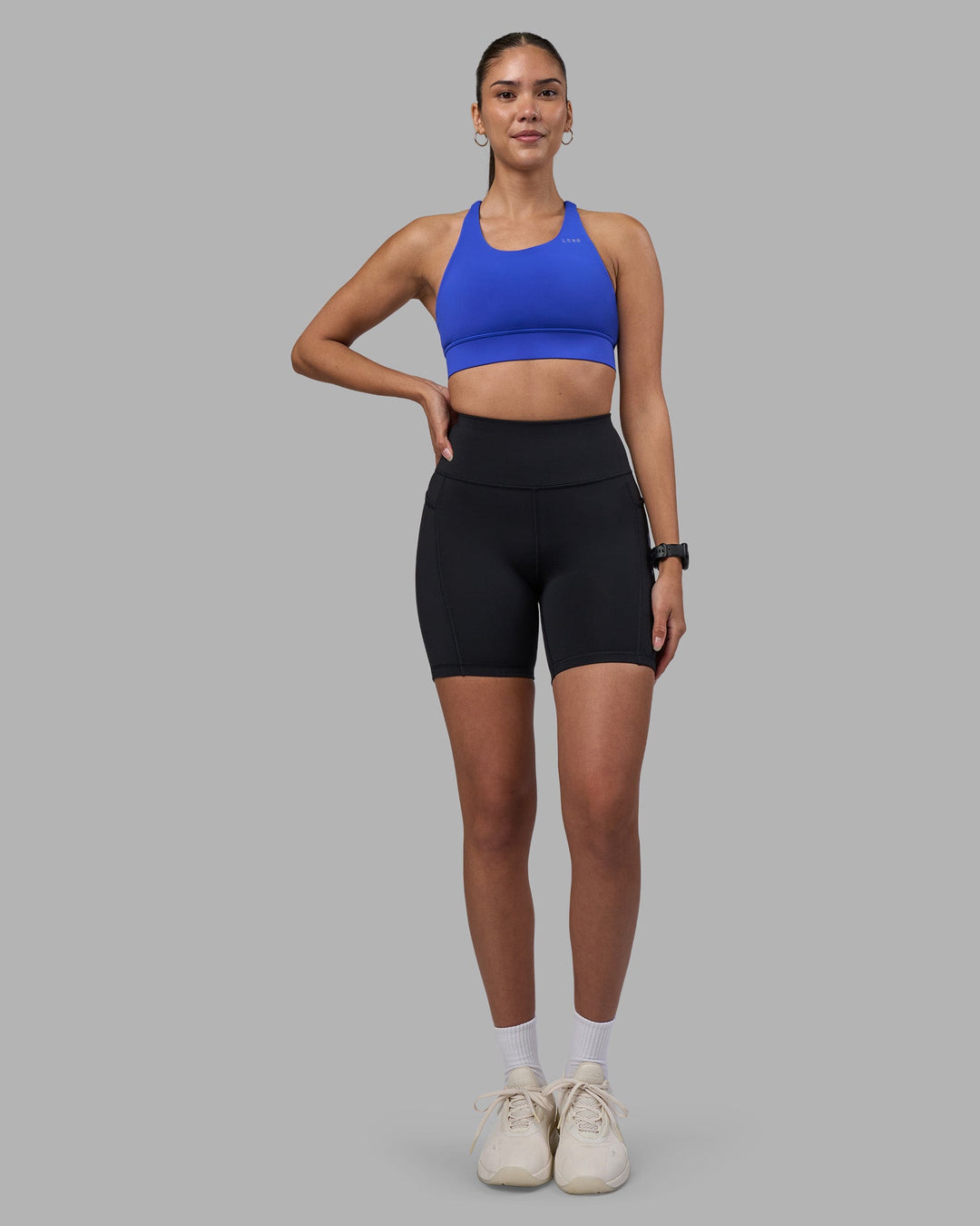 Woman wearing Rep Ultra High-Rise 6&quot; Short Pockets - Black-Power Cobalt | Model:Rhiley | Size:S