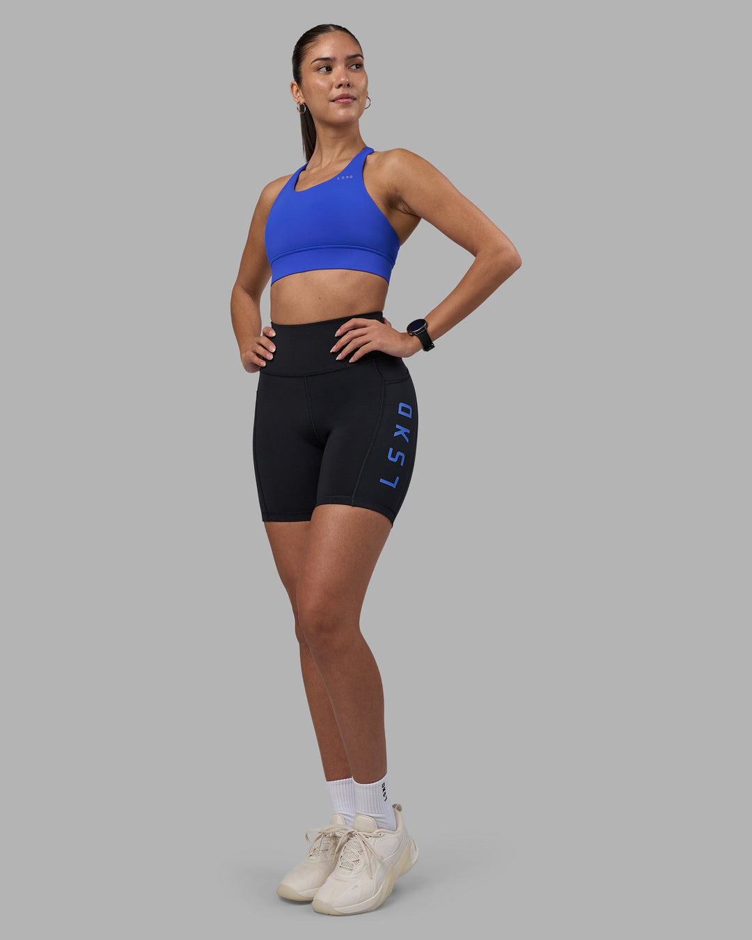 Woman wearing Rep Ultra High-Rise 6&quot; Short Pockets - Black-Power Cobalt | Model:Rhiley | Size:S