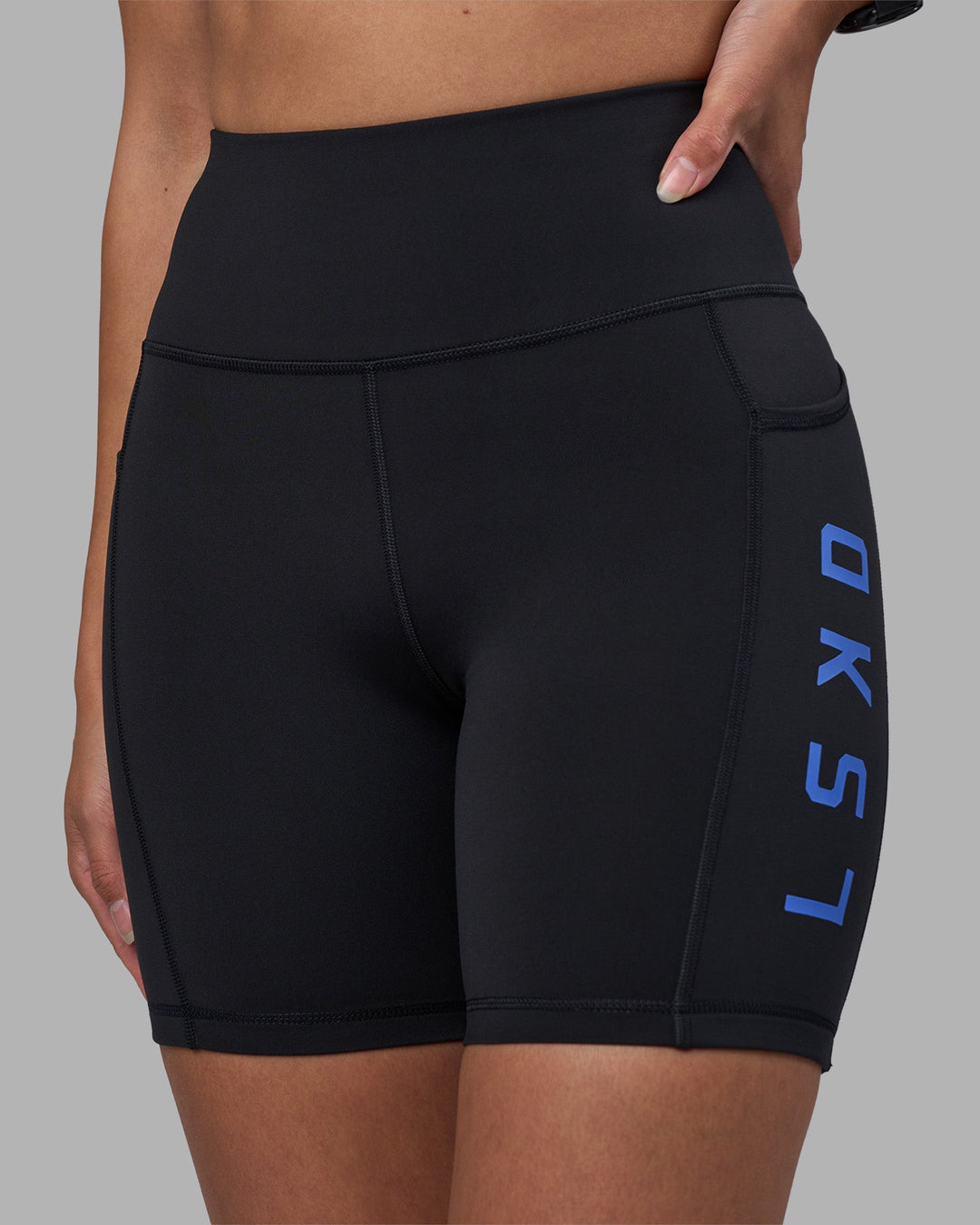 Woman wearing Rep Ultra High-Rise 6&quot; Short Pockets - Black-Power Cobalt | Model:Rhiley | Size:S