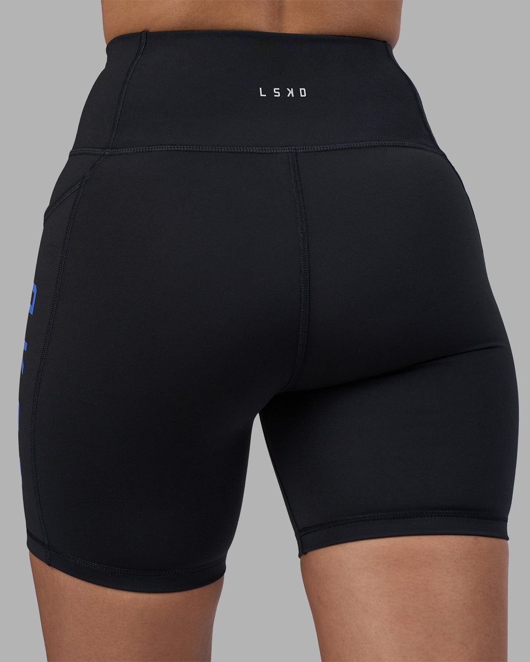 Woman wearing Rep Ultra High-Rise 6&quot; Short Pockets - Black-Power Cobalt | Model:Rhiley | Size:S