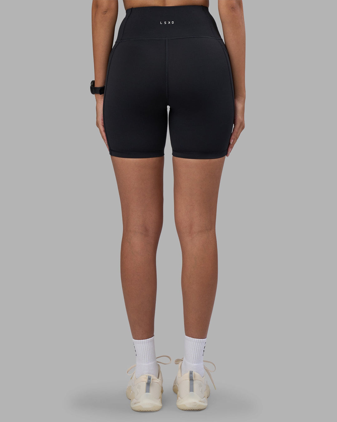 Woman wearing Rep Ultra High-Rise 6&quot; Short Pockets - Black-Power Cobalt | Model:Rhiley | Size:S