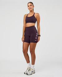 Woman wearing Rep Ultra High-Rise 6" Short Pockets - Midnight Plum-Marshmallow | Model:Rhiley | Size:S