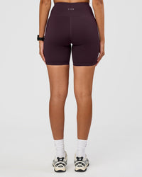 Woman wearing Rep Ultra High-Rise 6" Short Pockets - Midnight Plum-Marshmallow | Model:Rhiley | Size:S