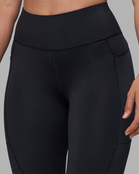 Woman wearing Rep Ultra High-Rise 7/8 Legging Pockets - Black-Blue Atoll | Model:Sophie | Size:S