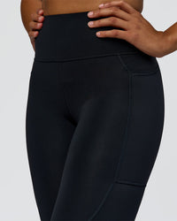 Woman wearing Rep Ultra High-Rise 7/8 Legging Pockets - Black-Palace Blue | Model:Rosie | Size:S