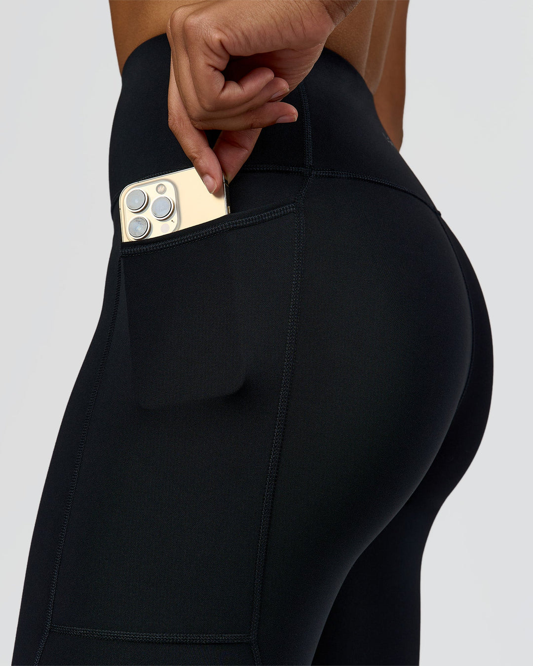 Woman wearing Rep Ultra High-Rise 7/8 Legging Pockets - Black-Palace Blue | Model:Rosie | Size:S