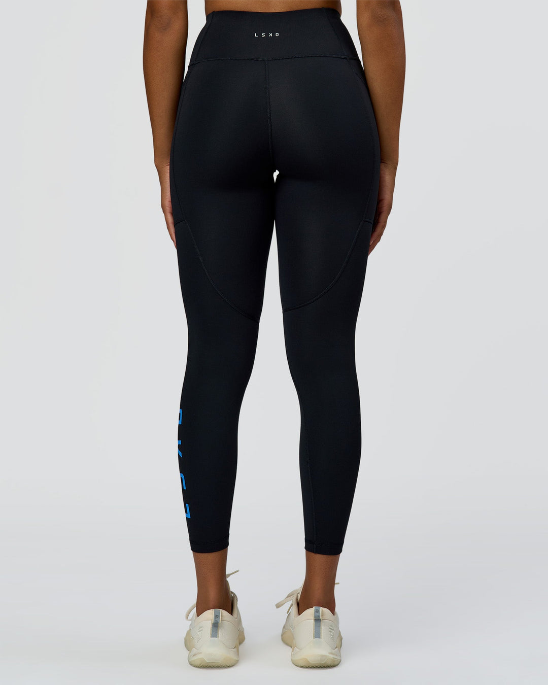 Woman wearing Rep Ultra High-Rise 7/8 Legging Pockets - Black-Palace Blue | Model:Rosie | Size:S