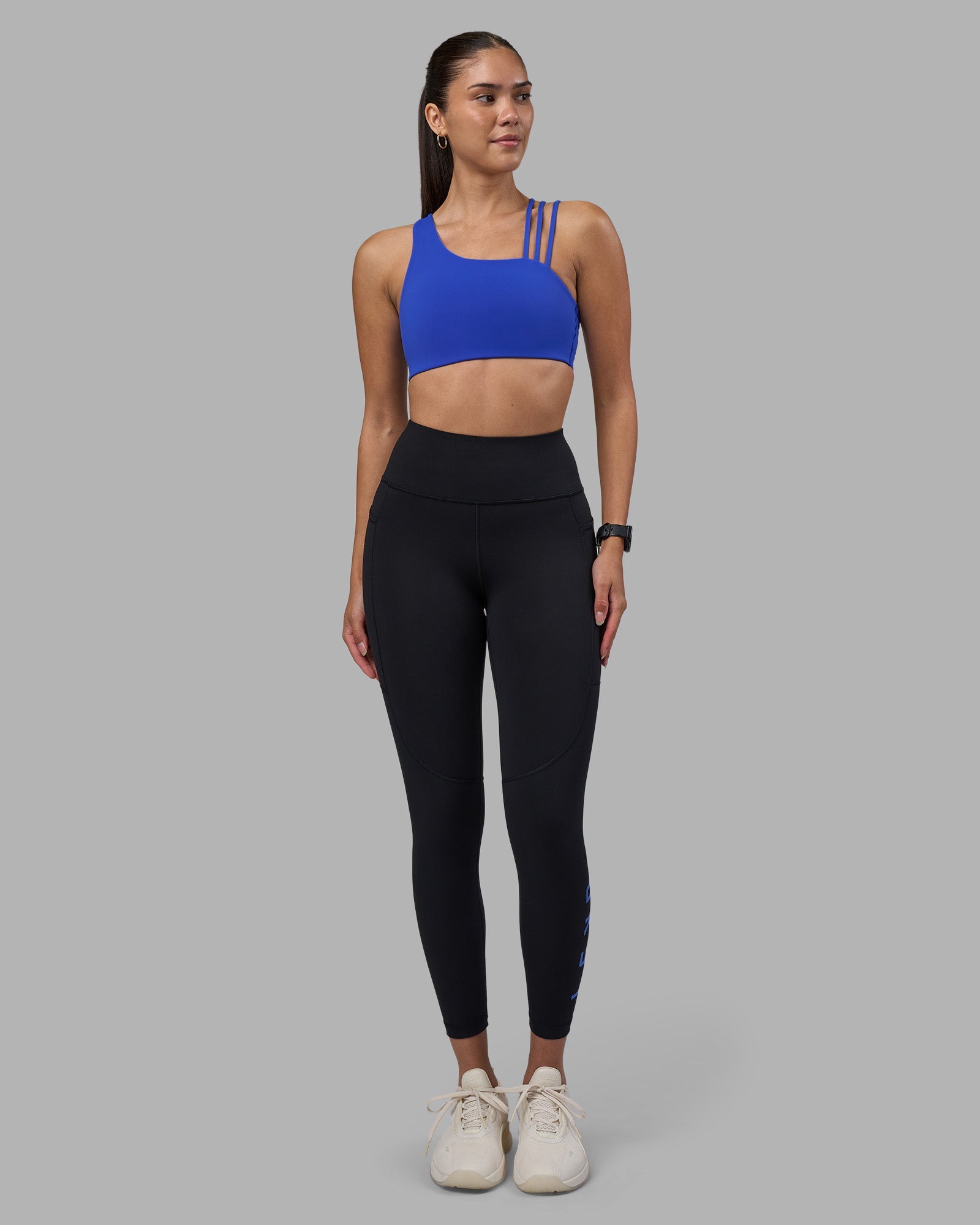 Woman wearing Rep Ultra High-Rise 7/8 Legging Pockets - Black-Power Cobalt | Model:Rhiley | Size:S