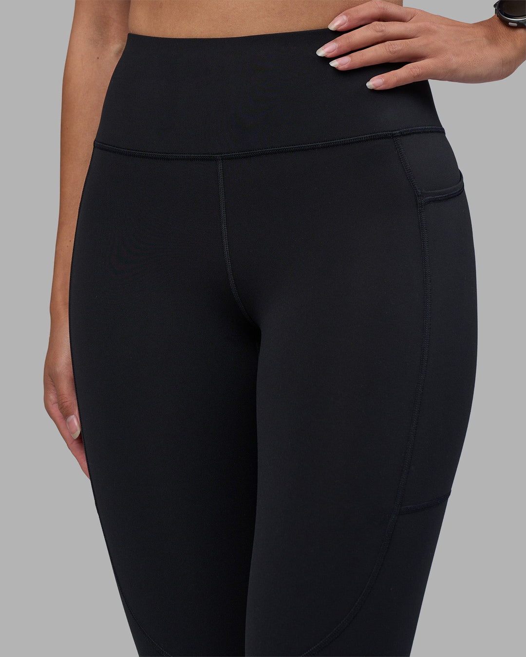 Woman wearing Rep Ultra High-Rise 7/8 Legging Pockets - Black-Power Cobalt | Model:Rhiley | Size:S