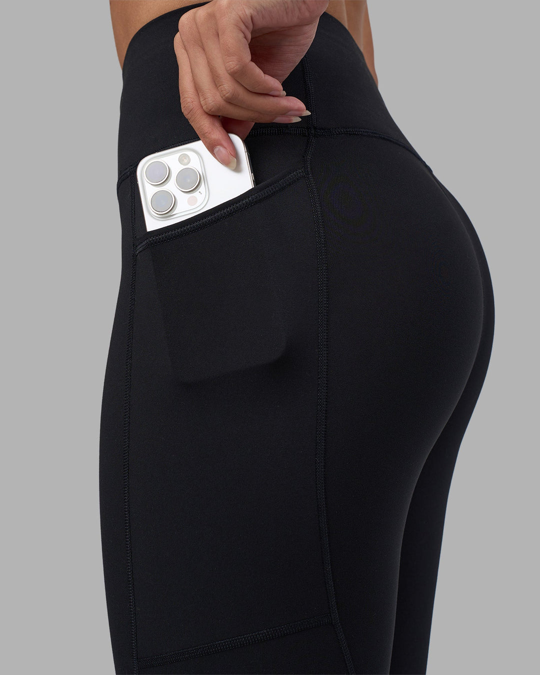 Woman wearing Rep Ultra High-Rise 7/8 Legging Pockets - Black-Power Cobalt | Model:Rhiley | Size:S