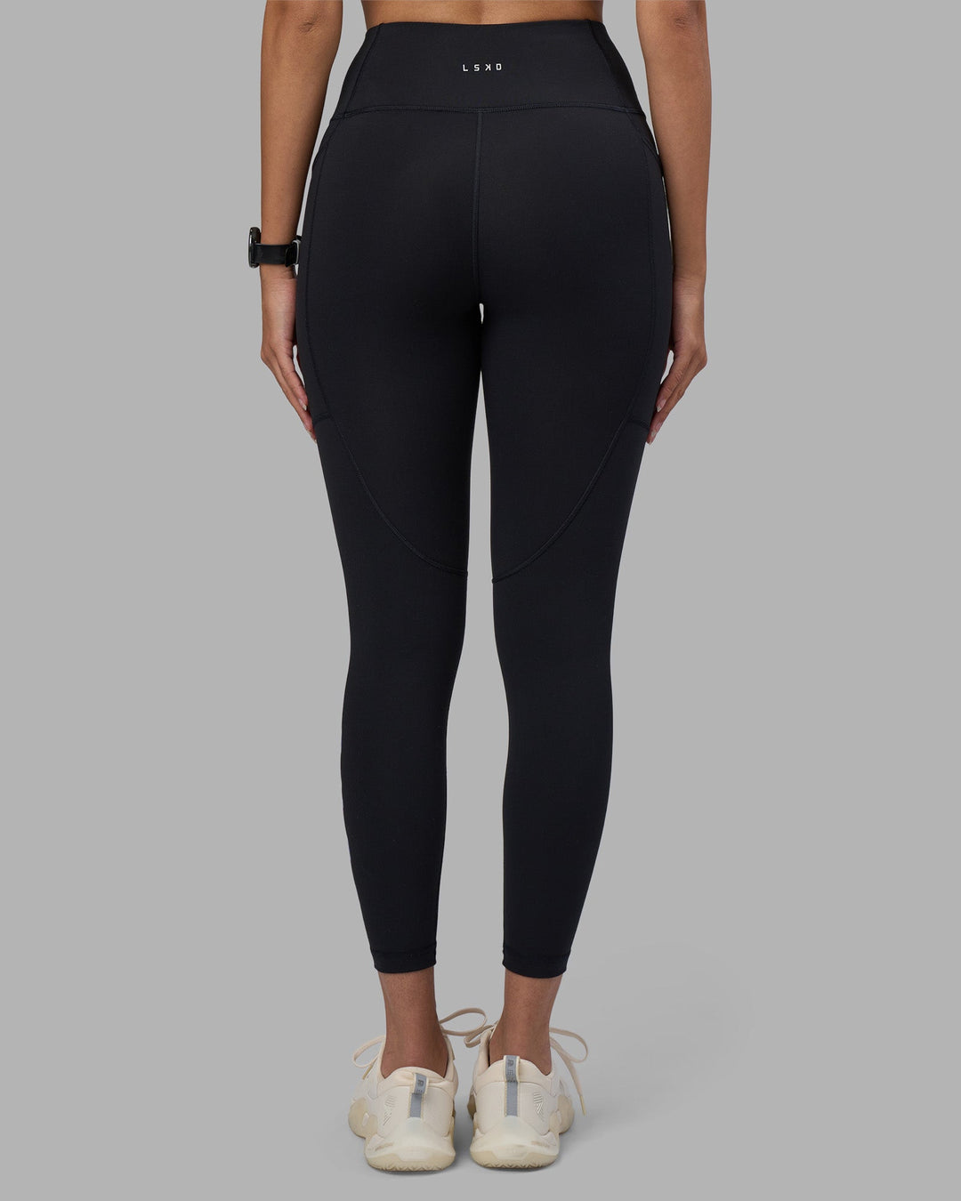 Woman wearing Rep Ultra High-Rise 7/8 Legging Pockets - Black-Power Cobalt | Model:Rhiley | Size:S