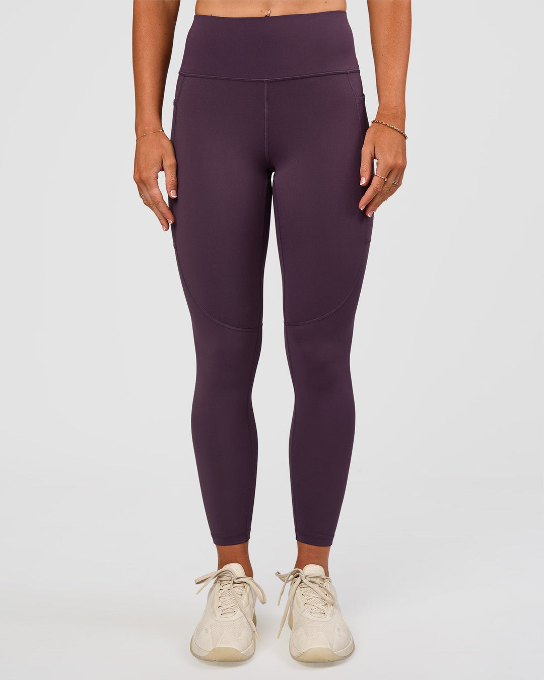 Woman wearing Rep Ultra High-Rise 7/8 Legging Pockets - Midnight Plum-Marshmallow | Model:Emelia | Size:S