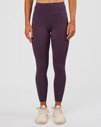 Woman wearing Rep Ultra High-Rise 7/8 Legging Pockets - Midnight Plum-Marshmallow | Model:Emelia | Size:S