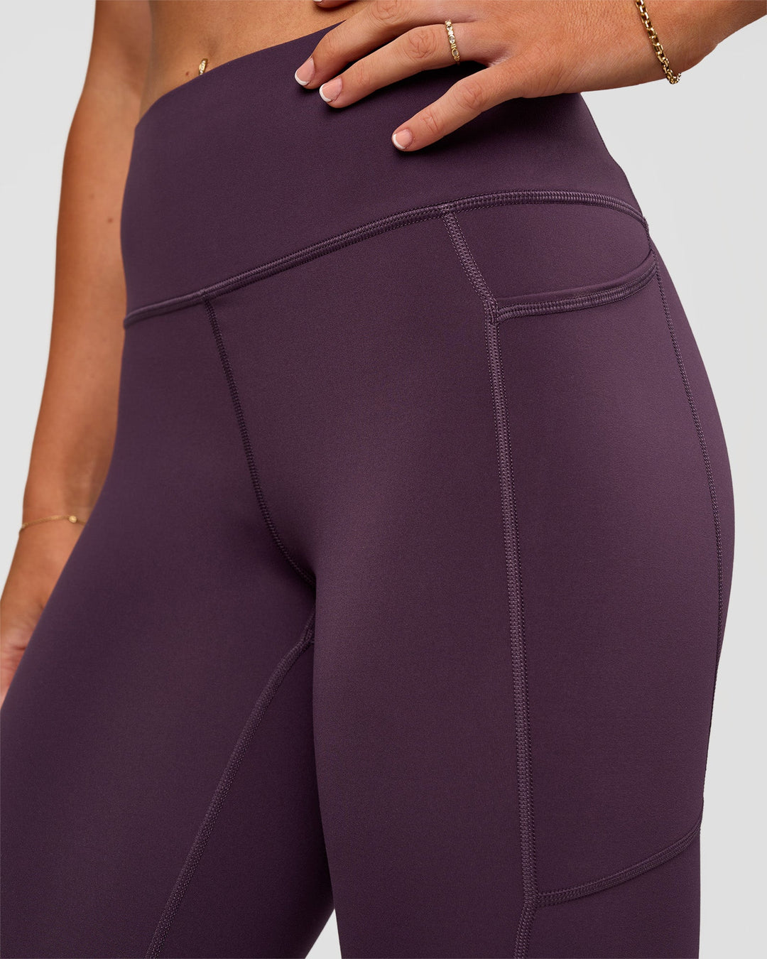 Woman wearing Rep Ultra High-Rise 7/8 Legging Pockets - Midnight Plum-Marshmallow | Model:Emelia | Size:S