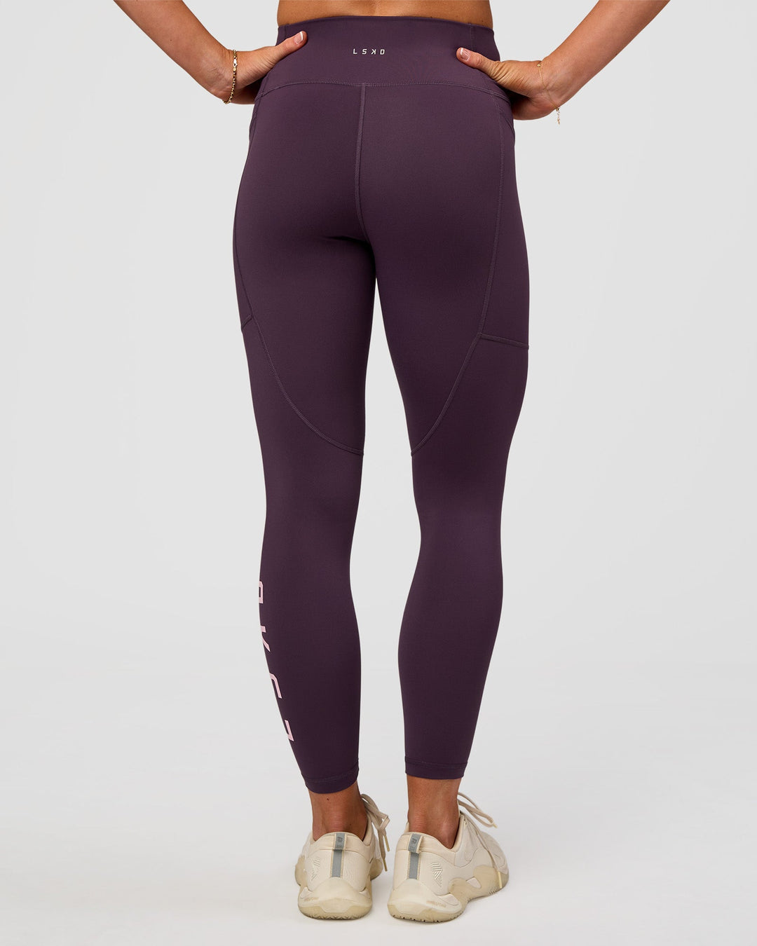 Woman wearing Rep Ultra High-Rise 7/8 Legging Pockets - Midnight Plum-Marshmallow | Model:Emelia | Size:S
