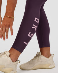 Woman wearing Rep Ultra High-Rise 7/8 Legging Pockets - Midnight Plum-Marshmallow | Model:Emelia | Size:S